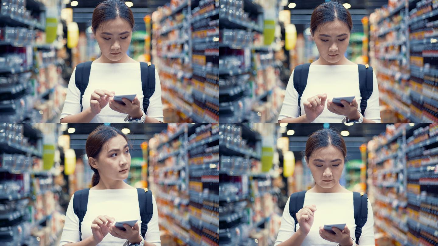在超市使用手机的女人