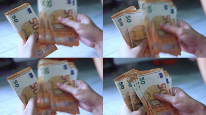 一名妇女手上数着欧元钞票