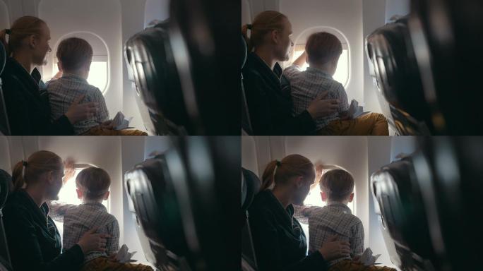 男孩和母亲透过飞机窗户向外看