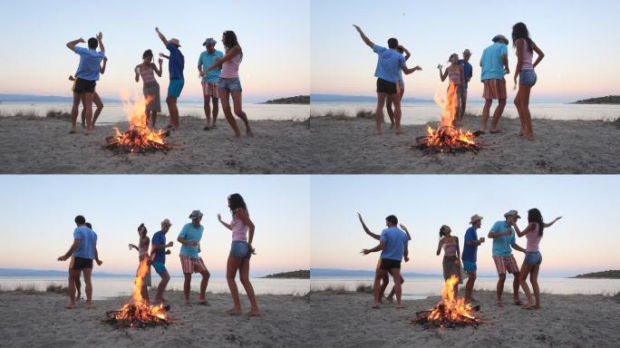 一群人在海滩篝火旁跳舞