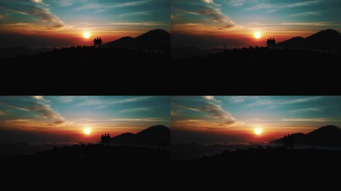 日出时分，人们站在巴厘岛巴图尔火山的顶部
