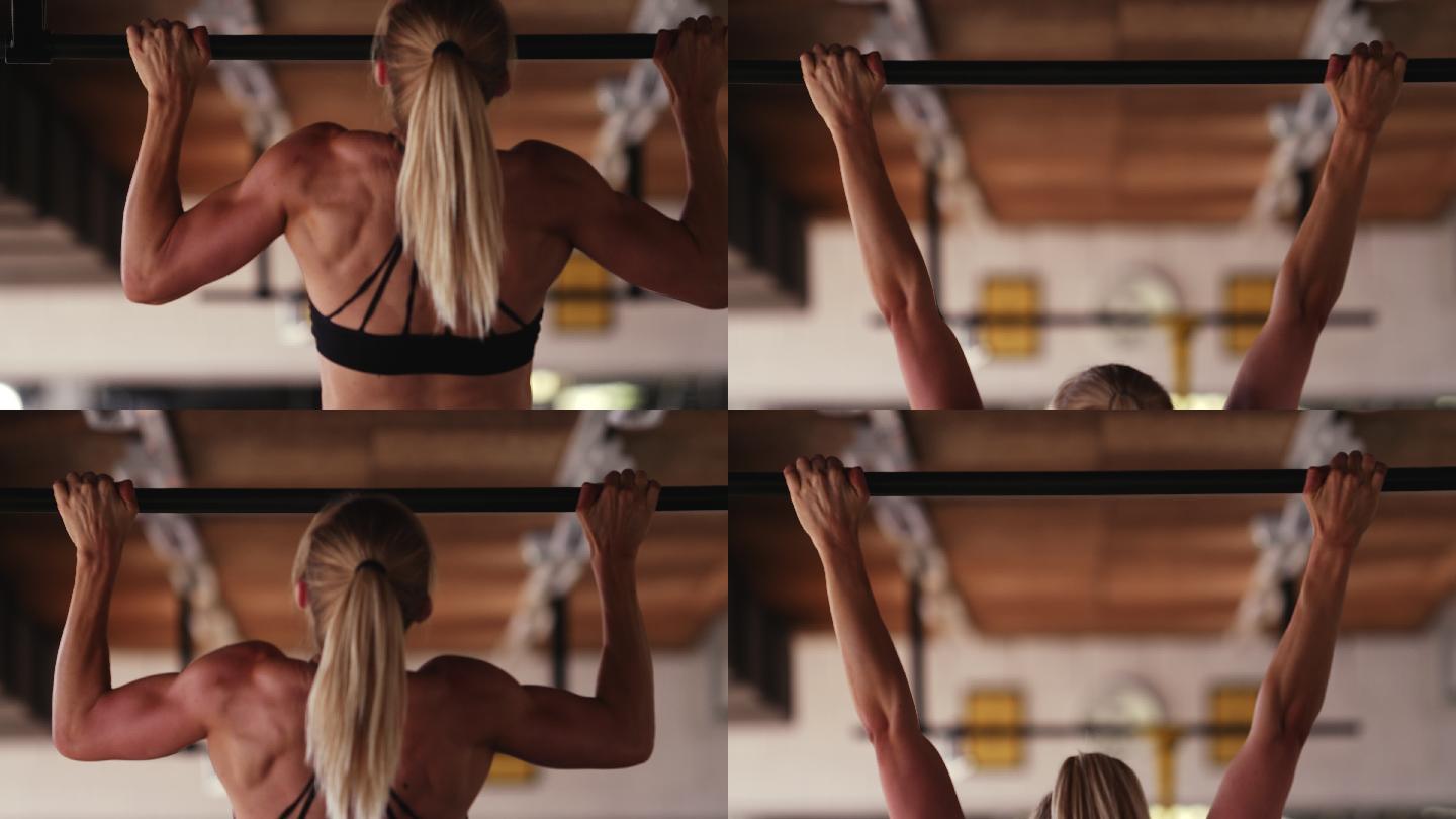 女运动员在健身房做引体向上的后视图。