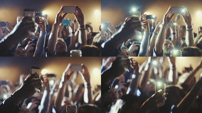 人们在音乐会上用智能手机拍照