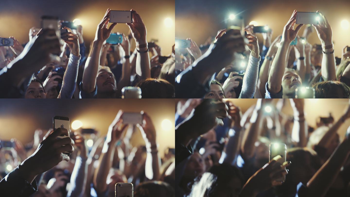 人们在音乐会上用智能手机拍照