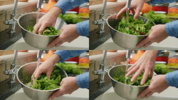 男子在洗绿叶蔬菜的特写镜头