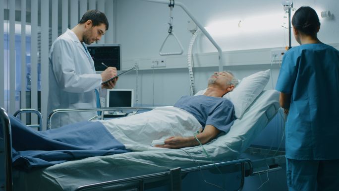 医生和护士进入病房检查躺在床上的病人。