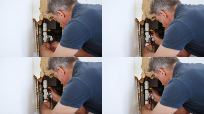 家用水管工用工具修复漏水管道的特写镜头