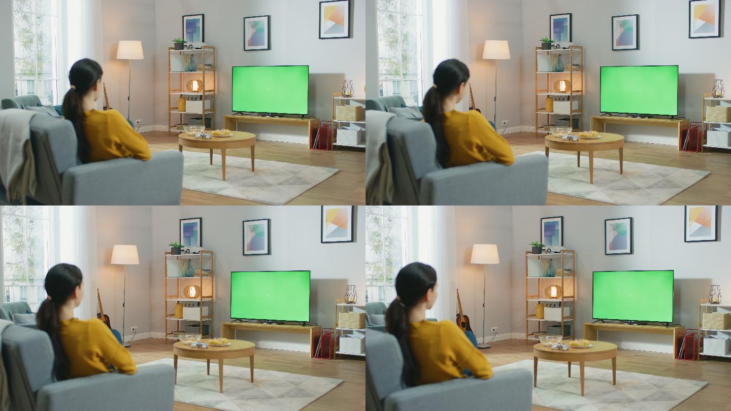 在看绿色屏幕电视的女人