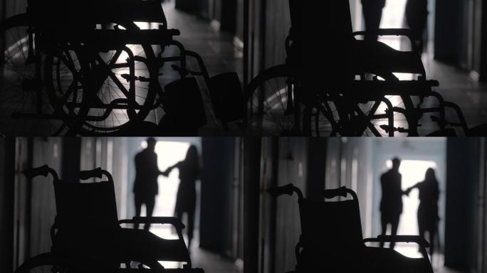 医院走廊中支撑跛行女子的男子侧影