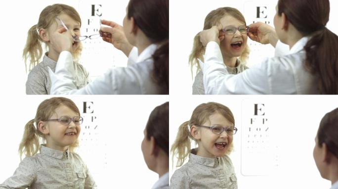 眼科医生给小女孩戴眼镜