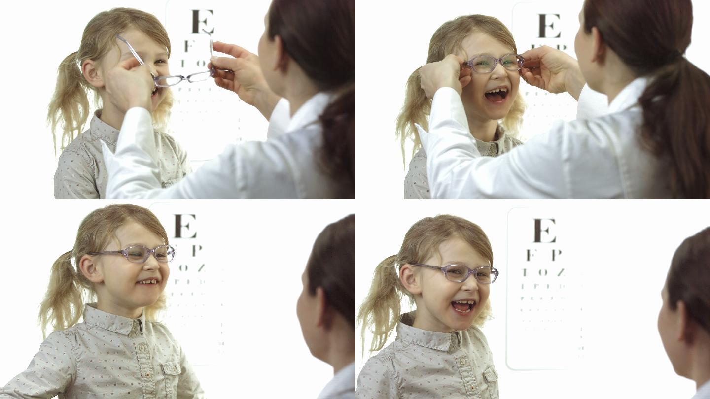 眼科医生给小女孩戴眼镜