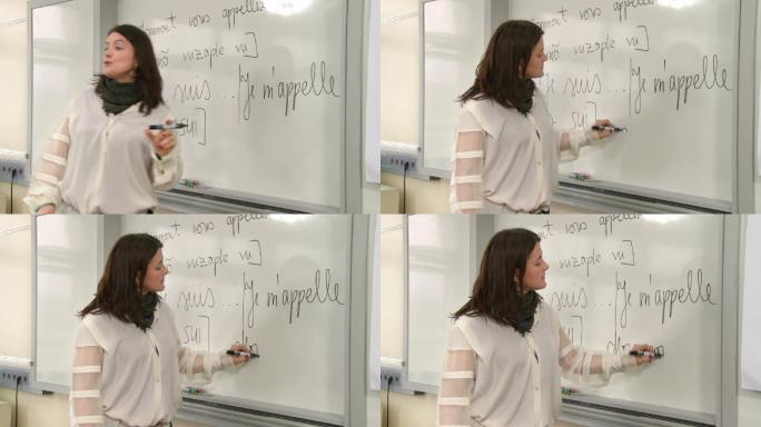 一位中年教授在课堂上讲法语时在黑板上写字
