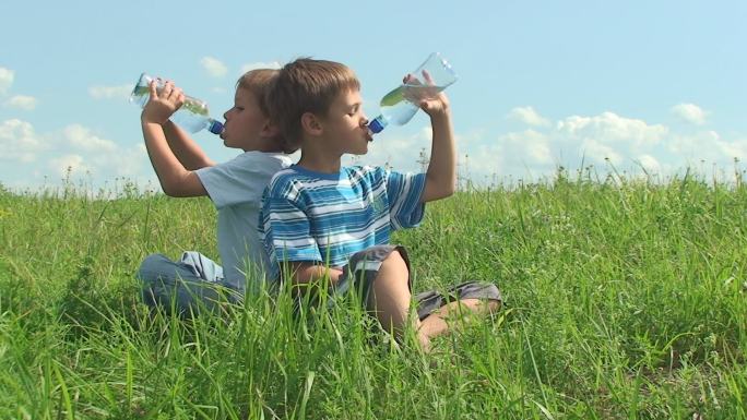 两个男孩在炎热的夏天喝水