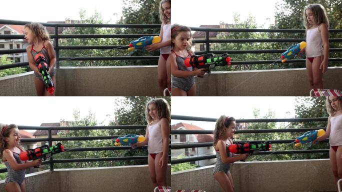 两个可爱的小女孩在玩水枪