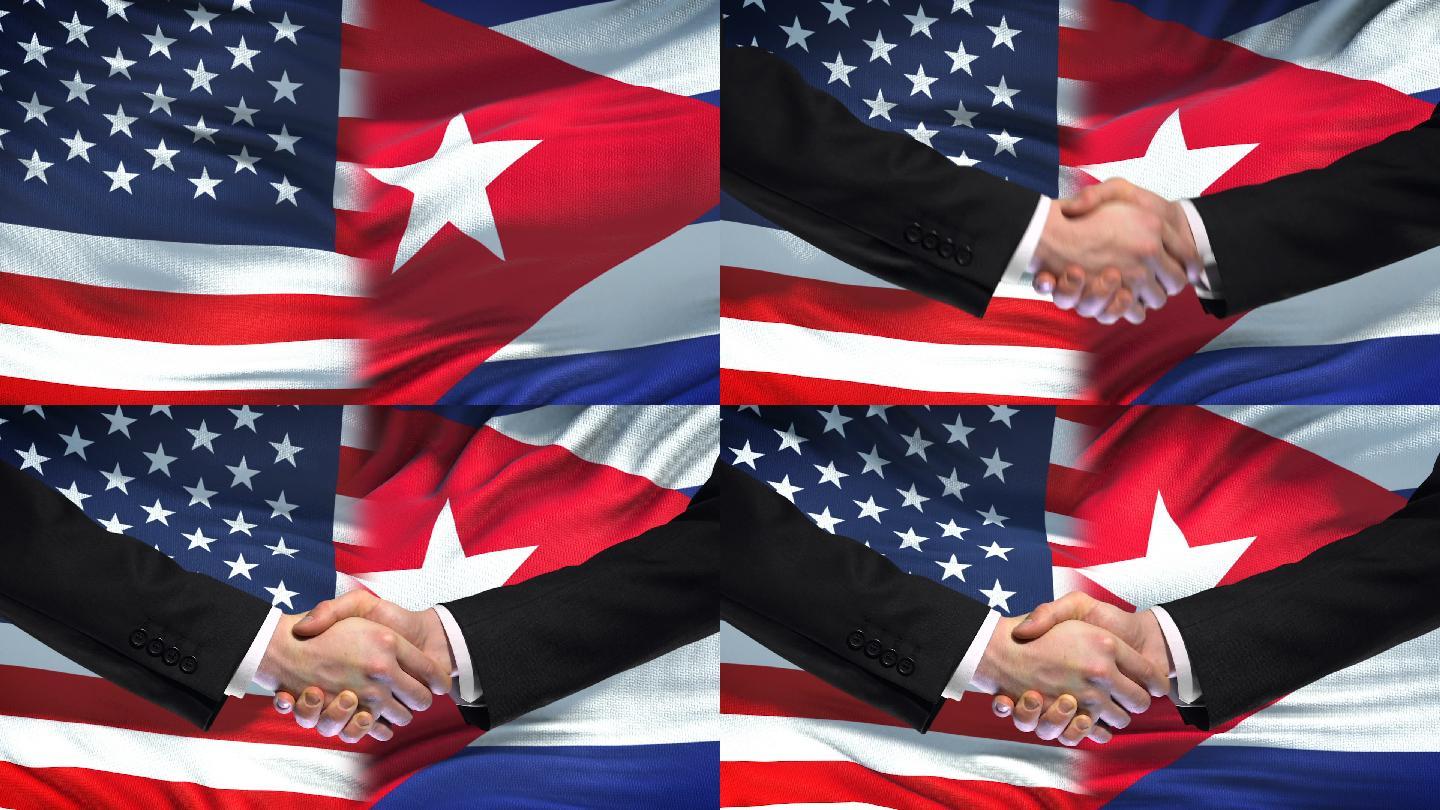 在美国和古巴国旗背景下握手