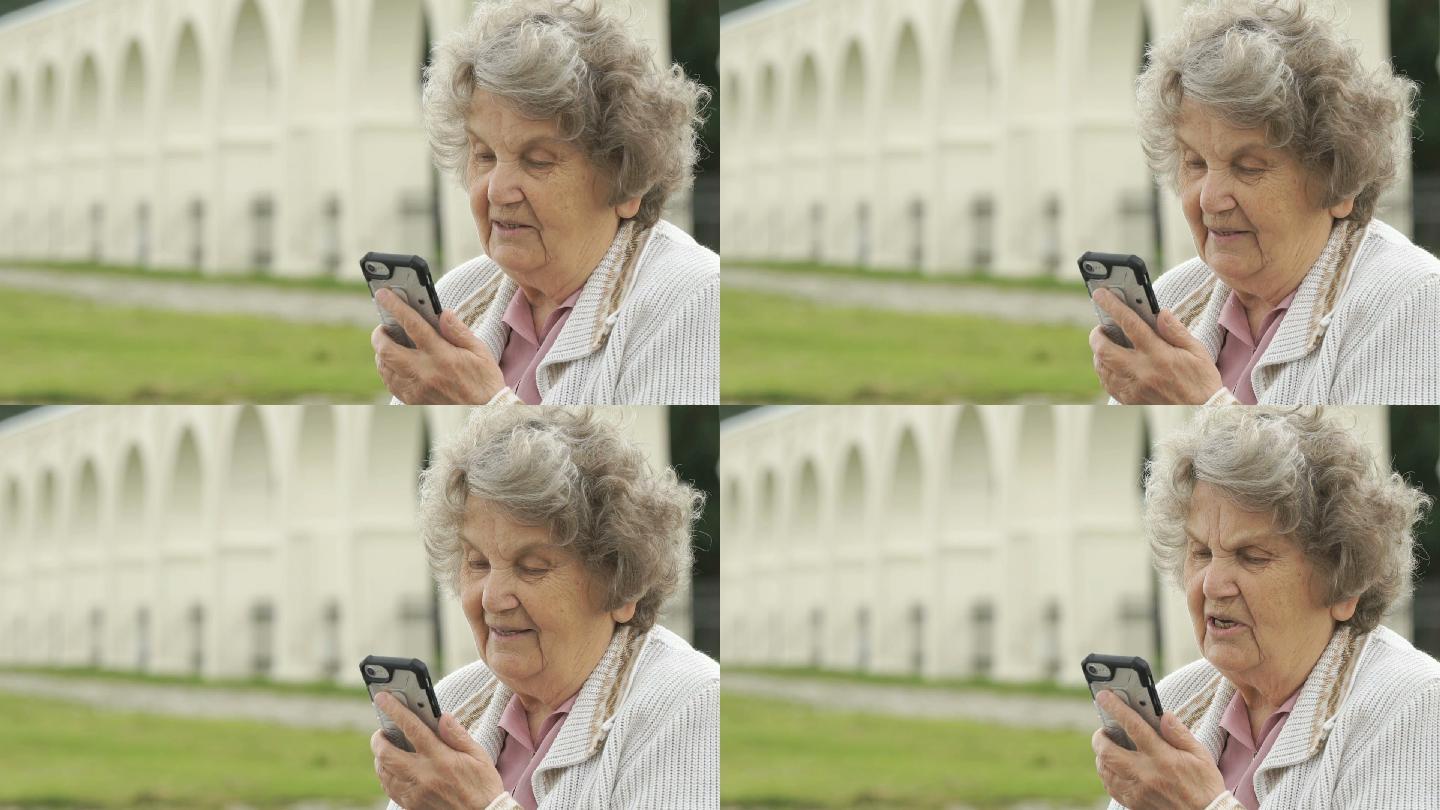 老妇人用智能手机和朋友聊天