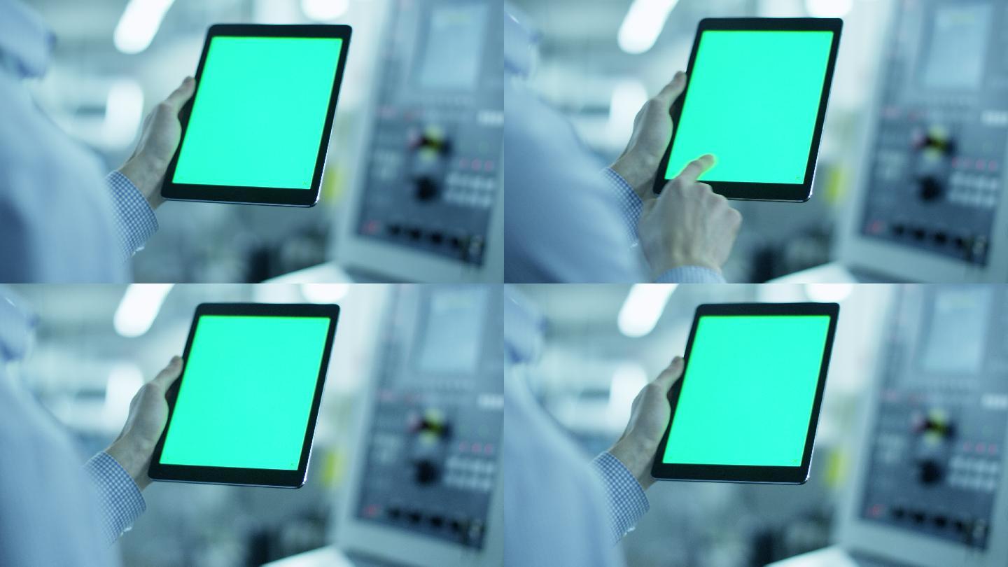 工人使用带绿色屏幕的平板电脑