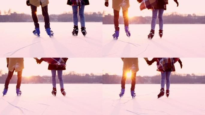 情侣手牵手在阳光明媚的冰冻湖面上滑冰。