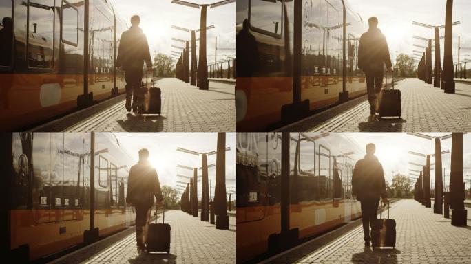 日落时分，带着行李的男子在火车站上行走