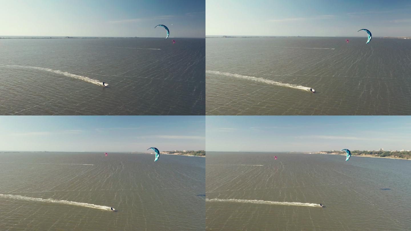 风筝冲浪者滑翔和跳跃穿越海洋的鸟瞰图