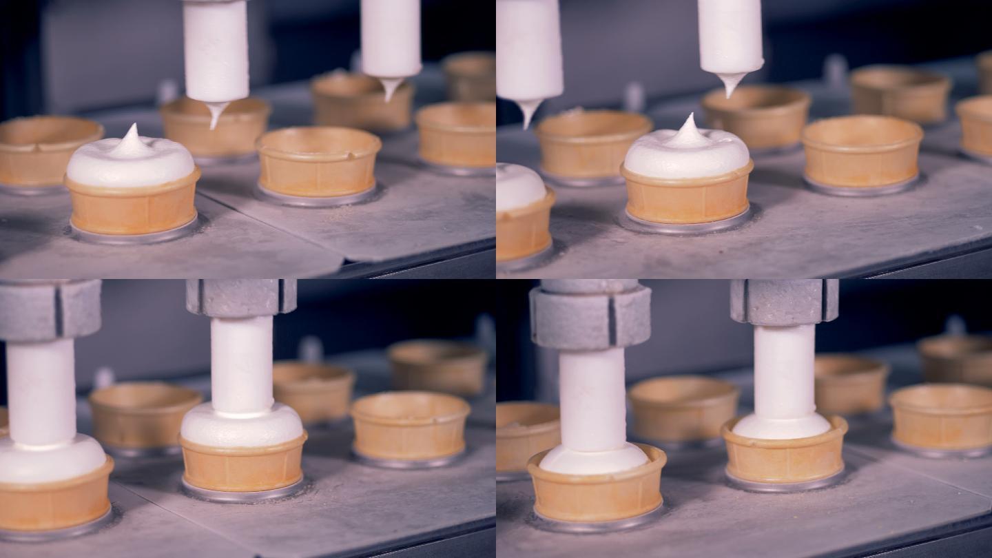 两个自动管道将奶油填充物泵入晶圆杯