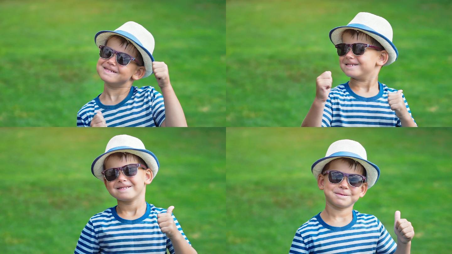 一个戴着太阳镜和帽子的快乐小男孩