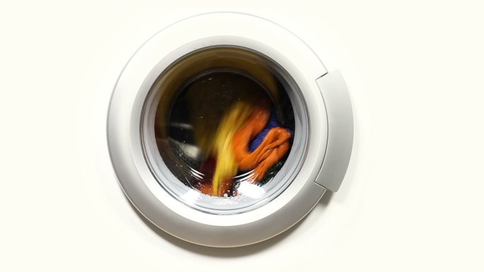 装满色彩鲜艳衣服的前置洗衣机。