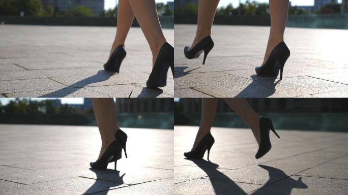 穿着高跟鞋的女性在城市街道上行走。