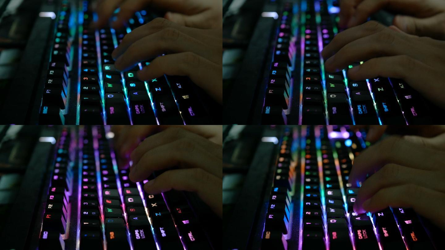 夜间男性在彩色发光键盘上打字的特写镜头