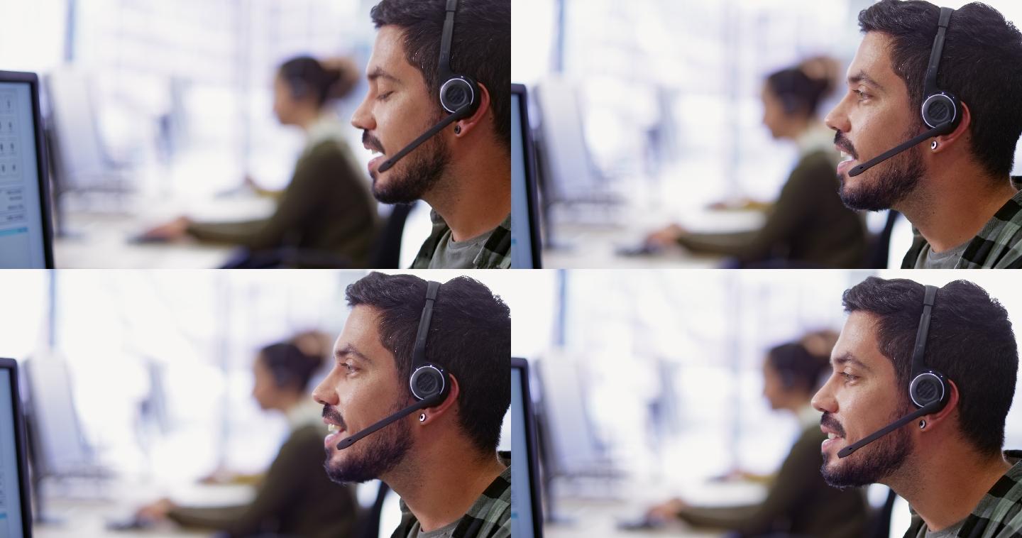 男性呼叫中心代理戴着无线耳机与客户交谈