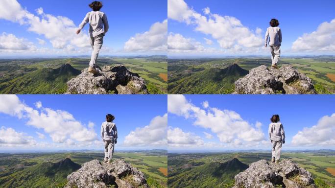 男人登上山顶 看远方拥抱自然