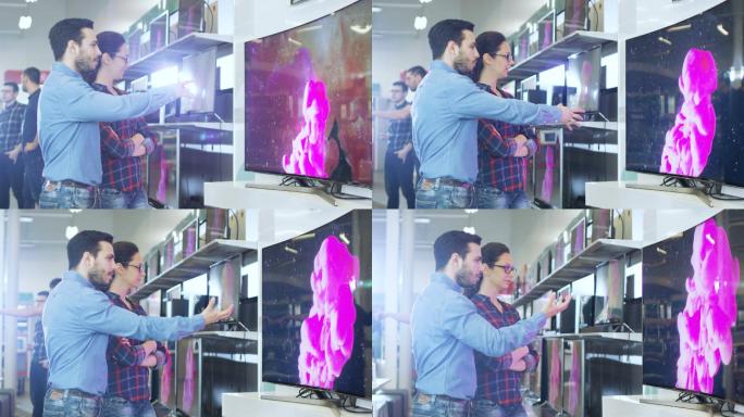 夫妇在商店购买一台新的4K超高清电视机