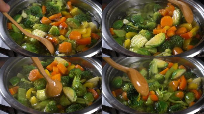 用木勺搅拌蔬菜汤胡萝卜新鲜度卷心菜
