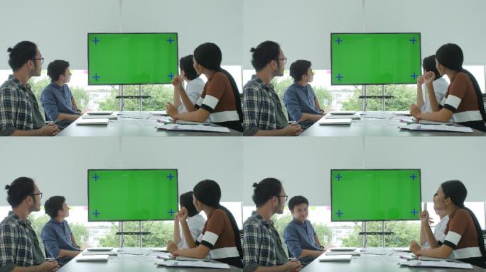 创意商业团队在会议室看着绿色屏幕鼓掌
