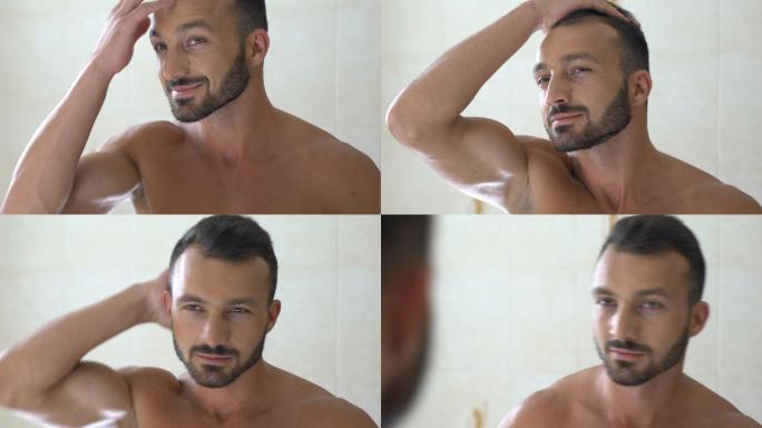 男人在浴室镜子前检查头发