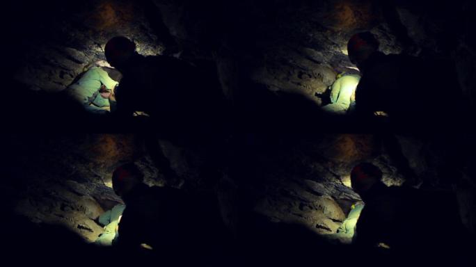 用手电筒探索黑暗洞穴的人