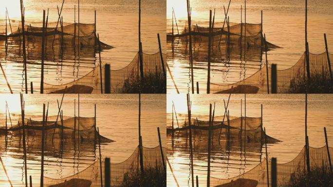 黄昏时分夕阳西下，小渔村河边渔网视频素材