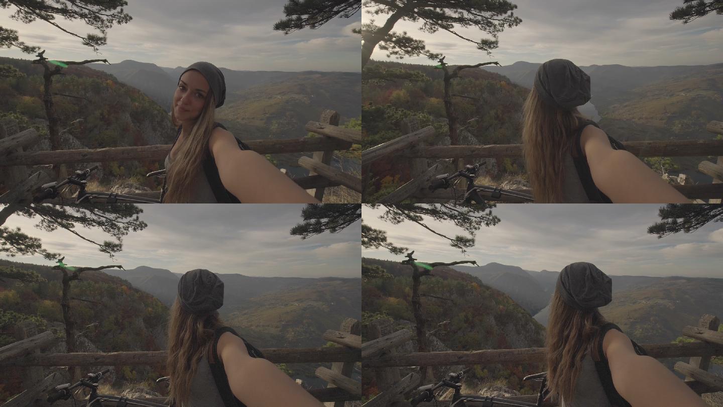 只有我在世界之巅，年轻女子站在悬崖上自拍