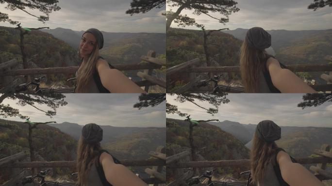 只有我在世界之巅，年轻女子站在悬崖上自拍