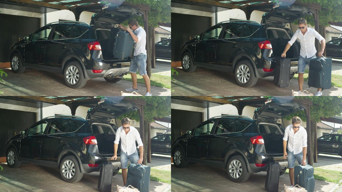 男子从黑色SUV中卸下沉重的行李箱。