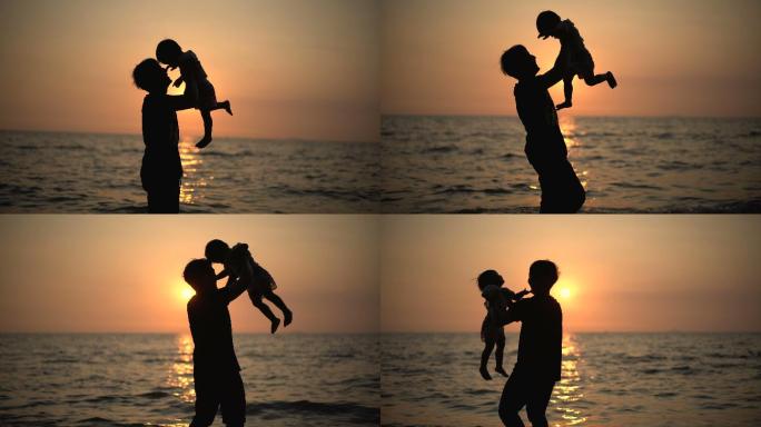 父亲在海滩上抱着男婴。