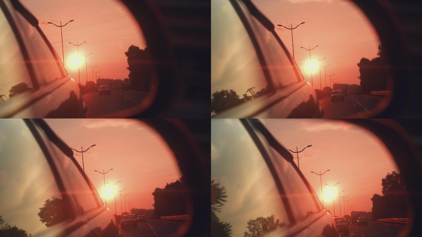 汽车行驶后视镜风景，夕阳下的城市街道