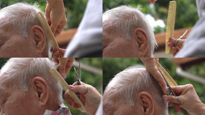 老年人在户外理发的照片