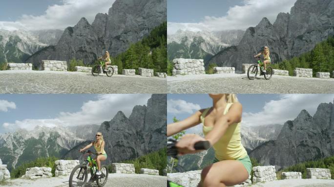 的女孩骑着自行车沿着陡峭的山路上坡