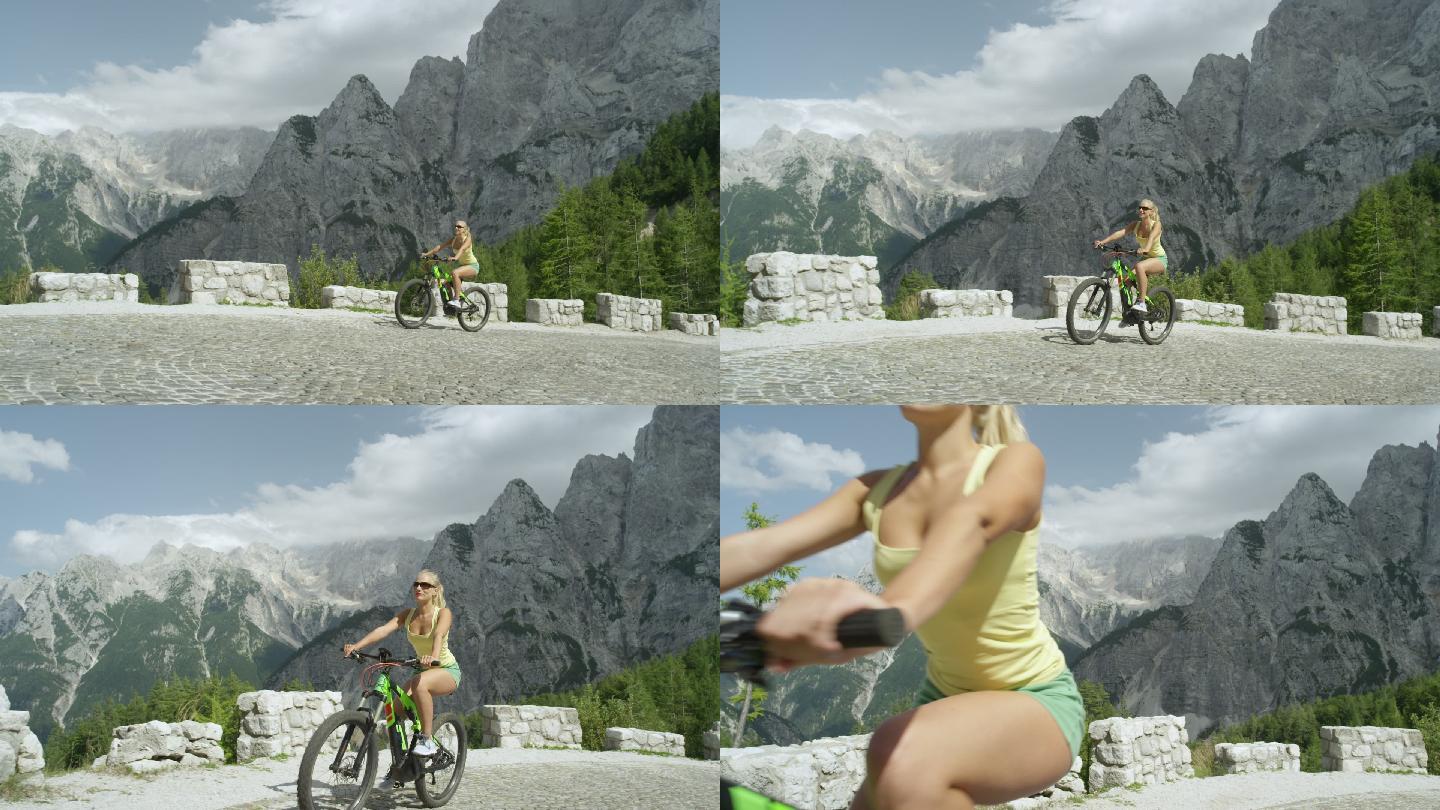 的女孩骑着自行车沿着陡峭的山路上坡
