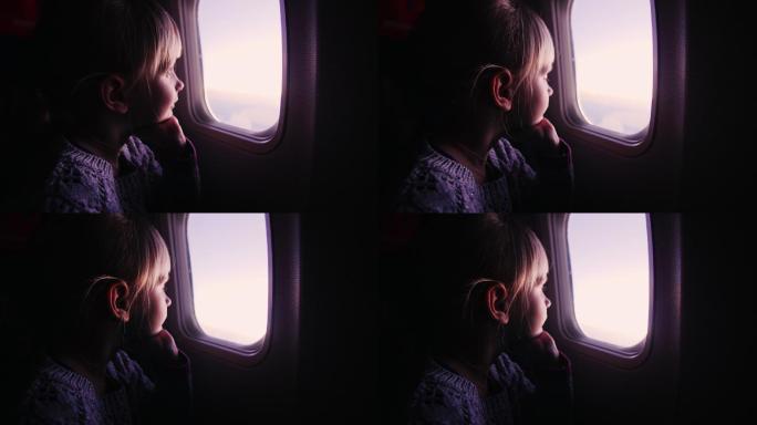 女孩坐在飞机上，看着窗外冉冉升起的太阳