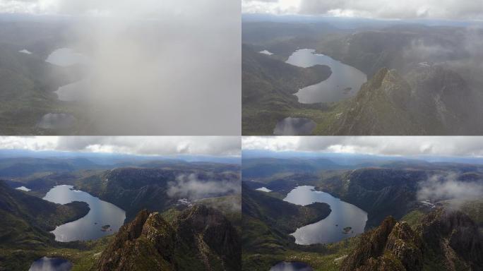 无人驾驶飞机穿越云层飞越山顶和湖泊