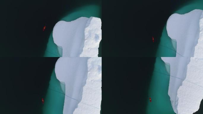 一艘皮划艇绕着冰山划过的空中镜头