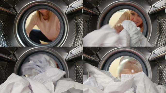 一位妇女正在把衣服放进洗衣机里
