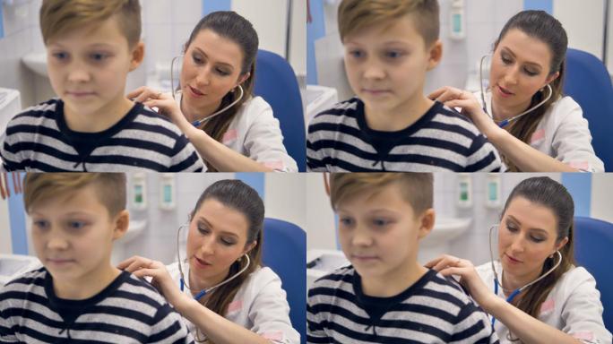 一位医生将听诊器举到一个男孩的背上的近景